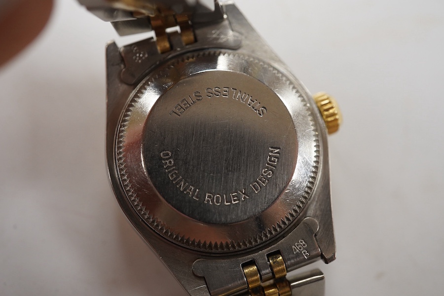 A lady's late 1980's steel and gold Rolex Oyster Perpetual Datejust wrist watch, with baton numerals, serial no. 9773085, on a steel and gold Rolex bracelet, no box or papers. Condition - poor to fair